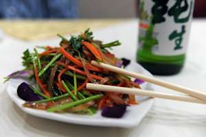 (HR) ABOVE: This is a plate of oxen penis, mixed with greens and carrots for an appetizer. Guo-li-zhuang is China's first speciality penis restaruant. It is in an elegantly restored house beside Beijing's West Lake. Customers can sample the organs of yaks